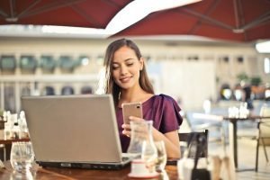 woman-happy-smile-computer-laptop-cafe-phone 3